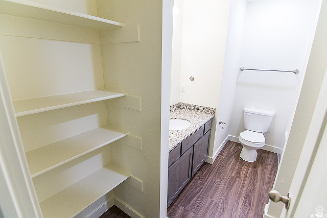 Bathroom with wood-type flooring, toilet, and vanity