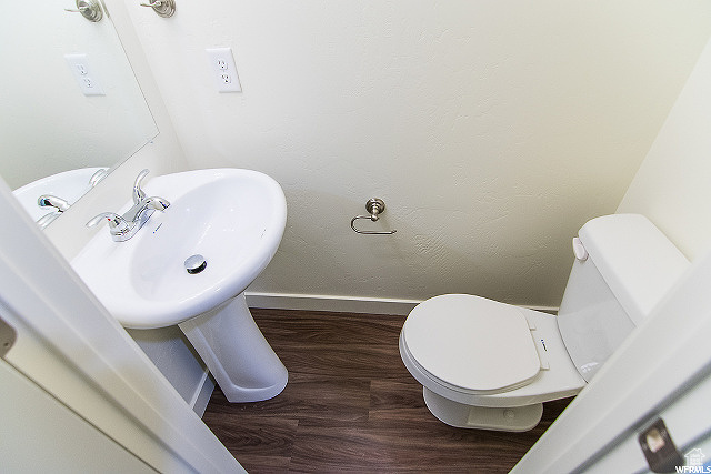 Bathroom with sink, toilet, and hardwood / wood-style floors