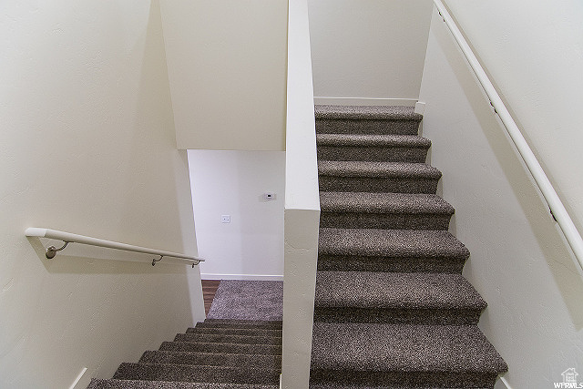 Stairs featuring hardwood / wood-style floors