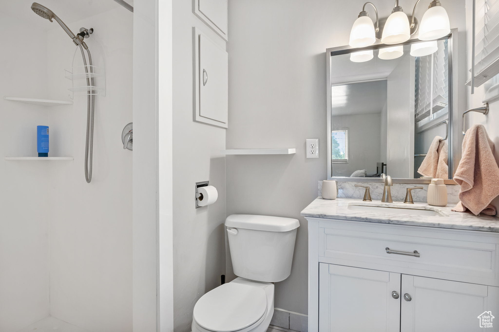 Bathroom with a shower, toilet, and vanity