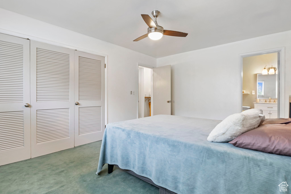 Bedroom featuring carpet, ceiling fan, and ensuite bathroom