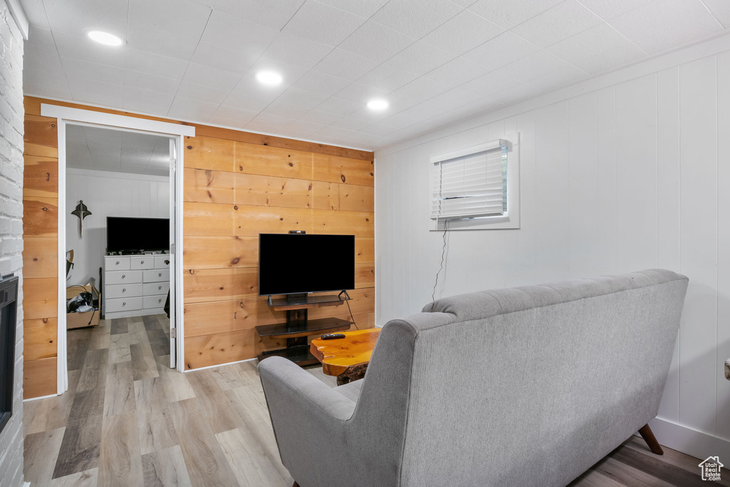 Living room featuring wooden walls and light wood-type flooring