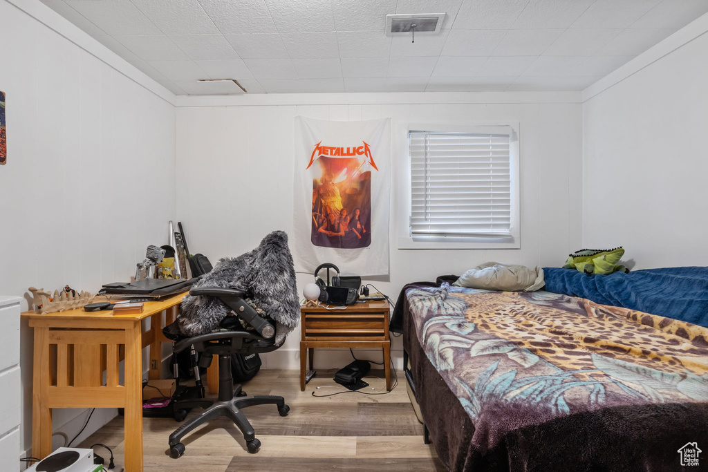 Bedroom with hardwood / wood-style flooring