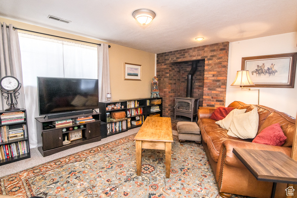 Living room with carpet and a wood stove