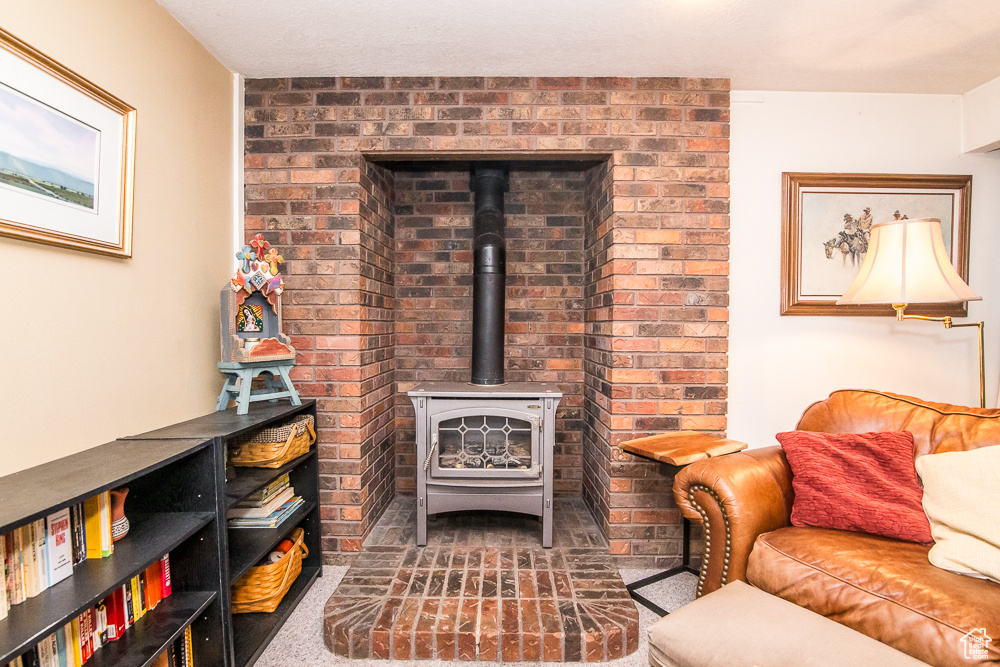 Living room with carpet flooring and a wood stove