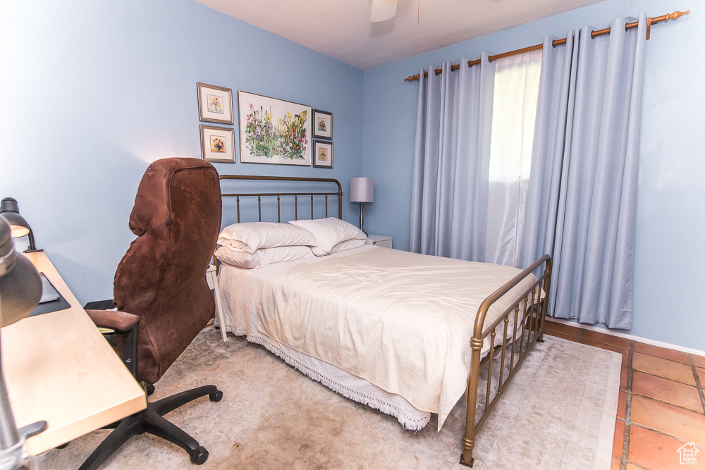 Bedroom with tile floors and ceiling fan