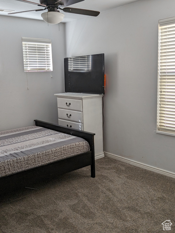 Bedroom featuring ceiling fan and carpet flooring