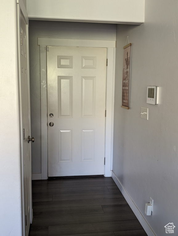 Hall with dark hardwood / wood-style floors