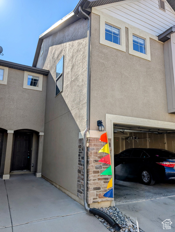 View of side of property with a garage