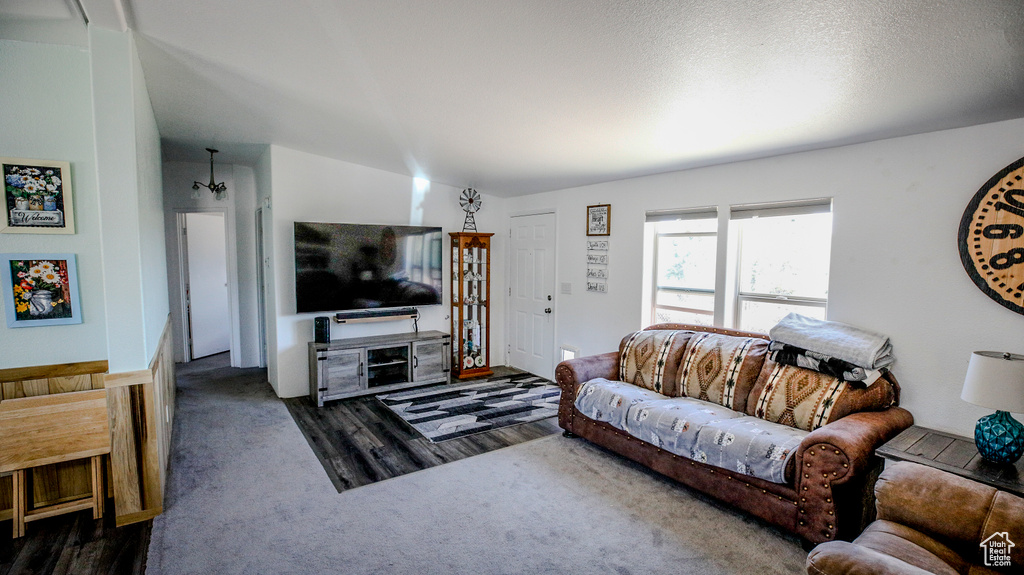 Carpeted living room featuring lofted ceiling