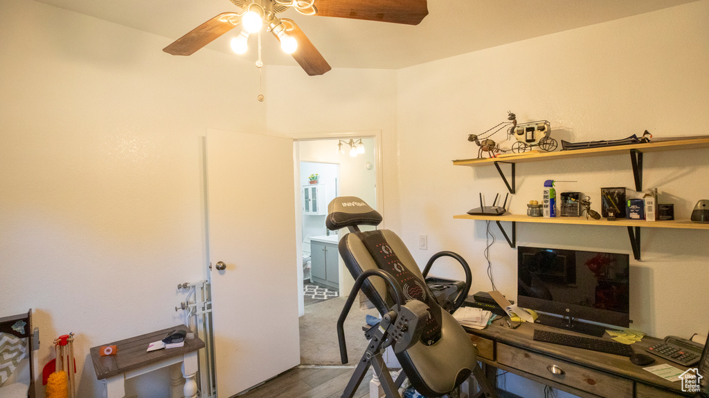 Home office featuring ceiling fan and wood-type flooring