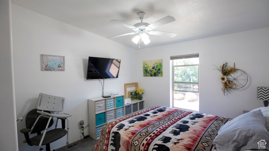 Carpeted bedroom with ceiling fan