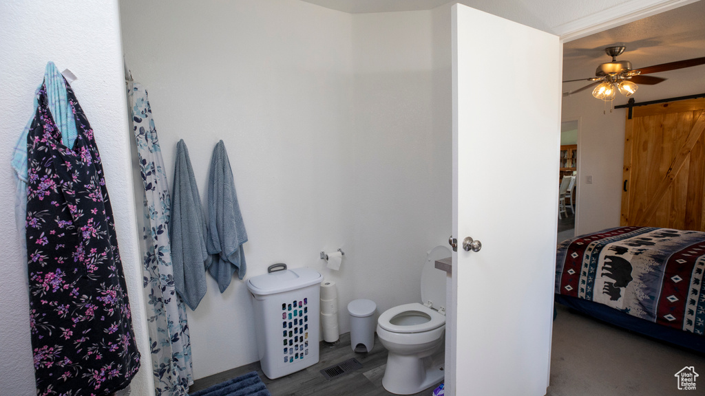 Bathroom with ceiling fan and toilet