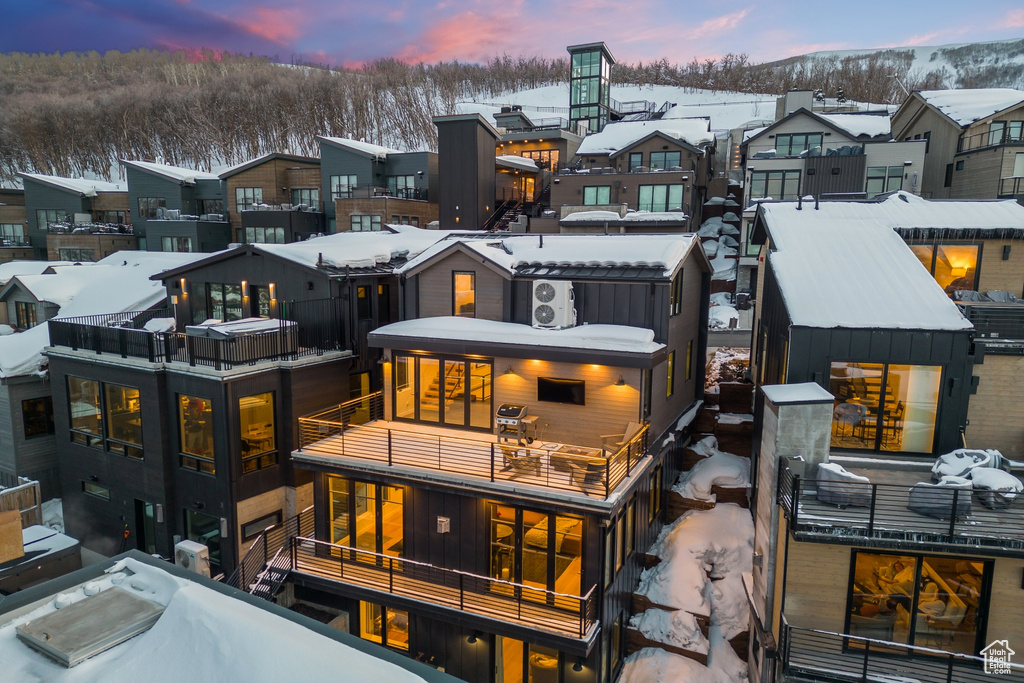 Snow covered house featuring a balcony