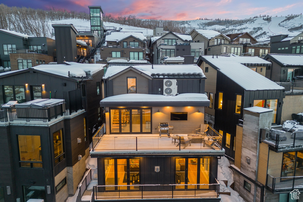 Snow covered property featuring a balcony