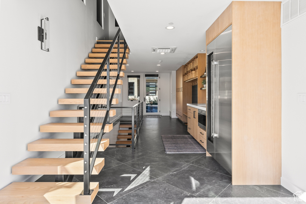 Staircase with dark tile flooring