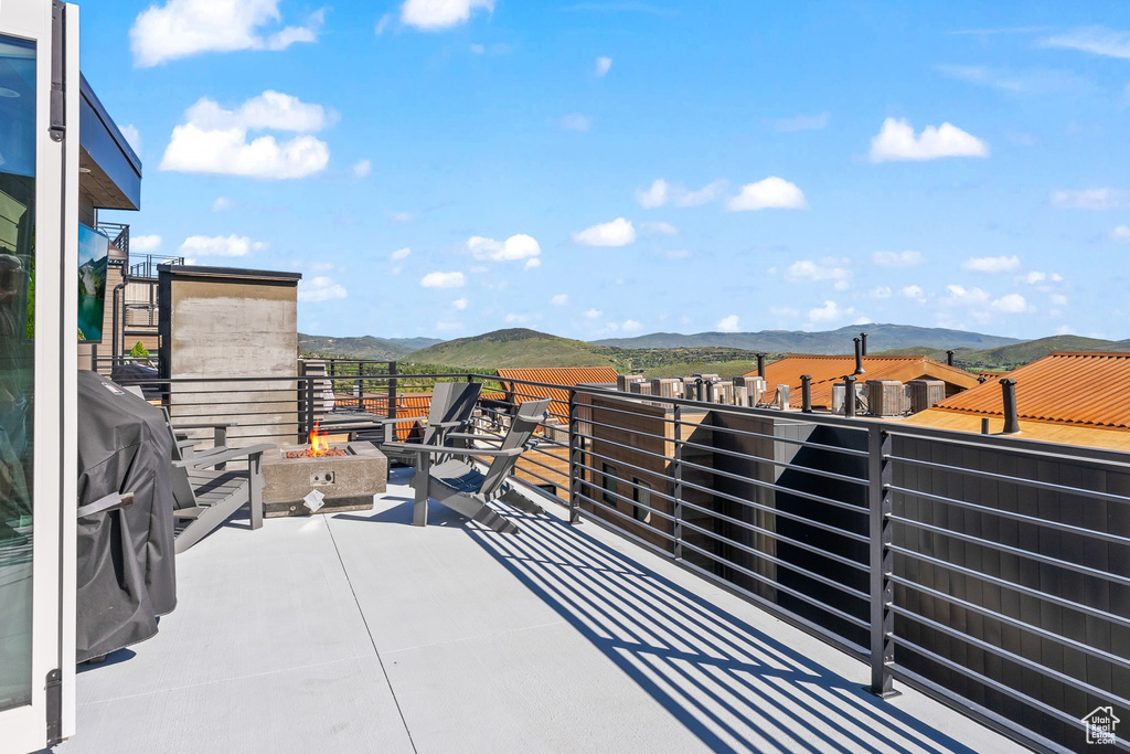 View of terrace featuring a balcony and a mountain view