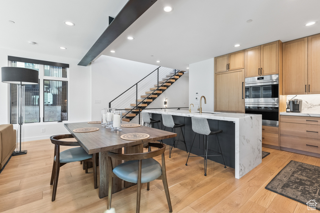 Dining area featuring sink and light wood-type flooring