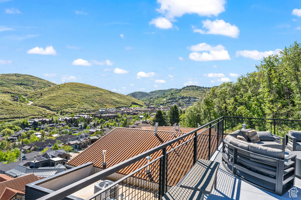 Balcony with a mountain view and central AC unit