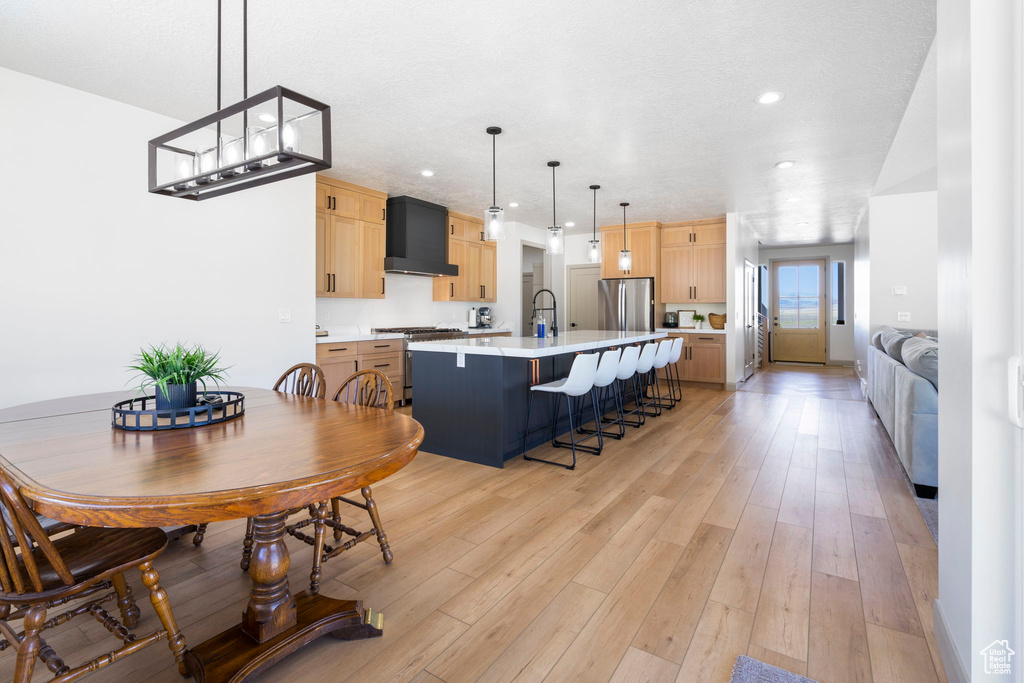 Dining room featuring sink and light hardwood / wood-style flooring