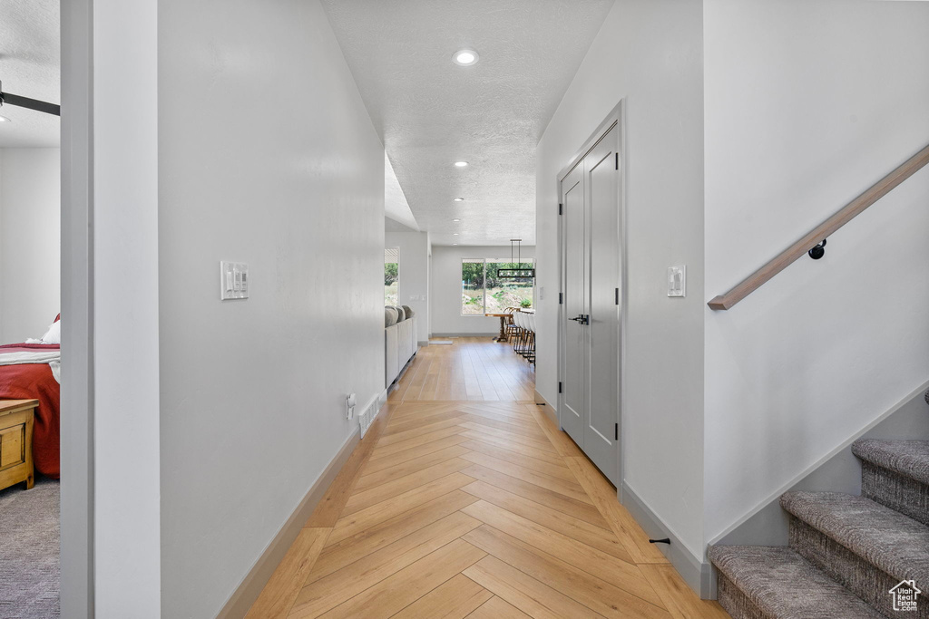 Hallway featuring light parquet floors