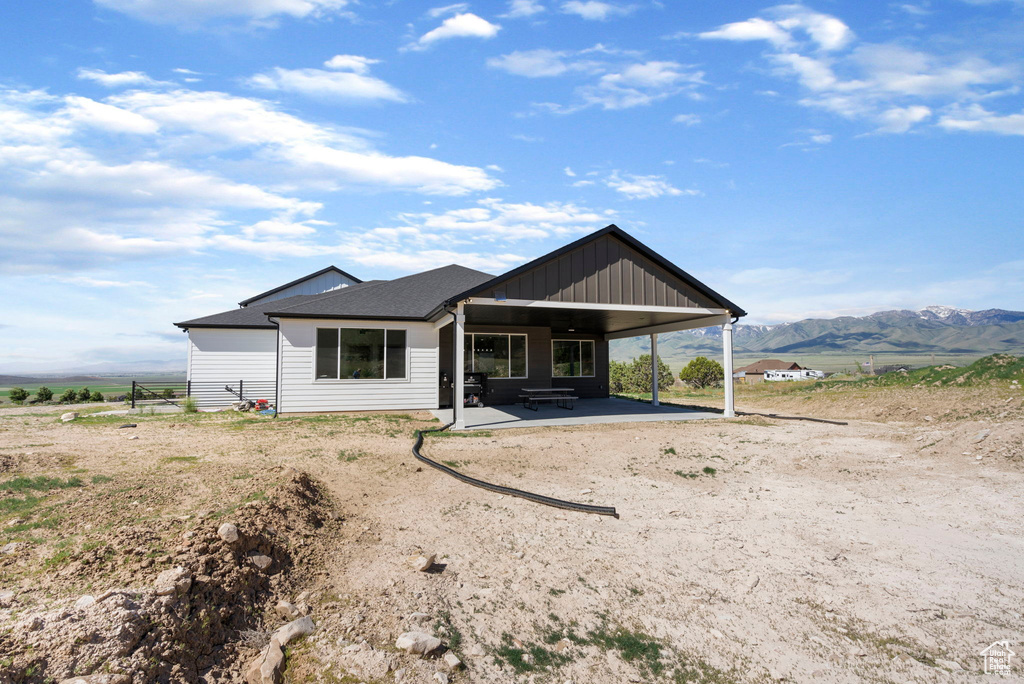 Ranch-style house with a carport and a mountain view