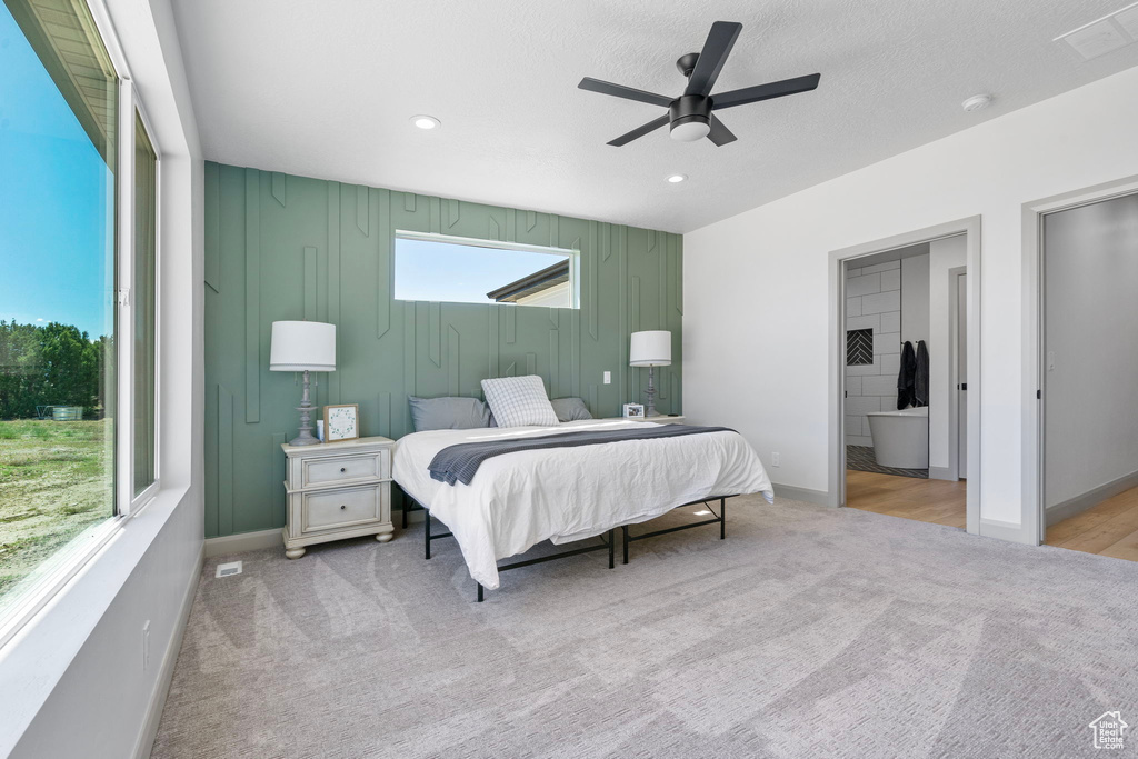 Bedroom featuring ceiling fan and light colored carpet