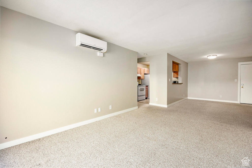 Interior space featuring light carpet and a wall mounted AC