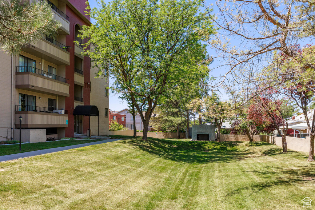 View of yard with a shed and a balcony