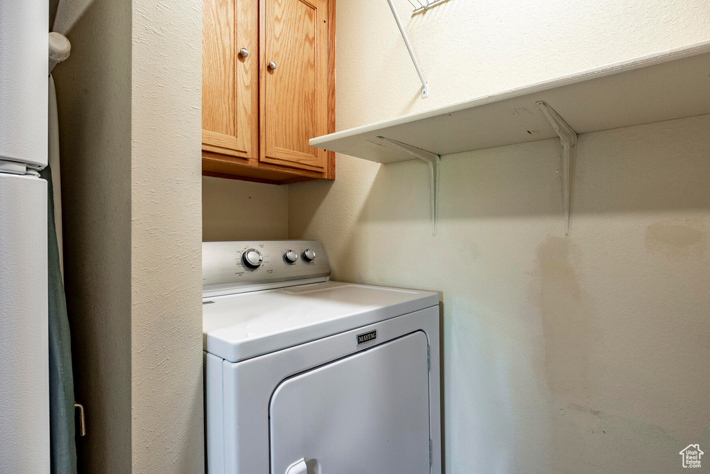 Laundry area featuring cabinets and washer / dryer