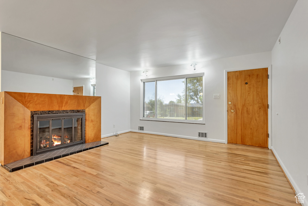 Unfurnished living room featuring light hardwood / wood-style floors