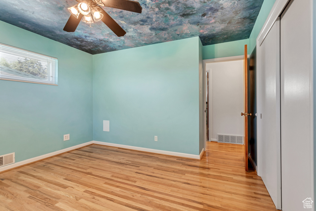 Spare room featuring ceiling fan and light hardwood / wood-style flooring