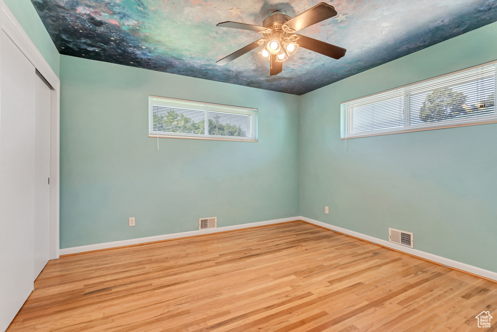 Interior space featuring hardwood / wood-style flooring, a closet, and ceiling fan