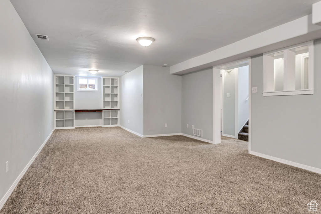 Basement featuring carpet