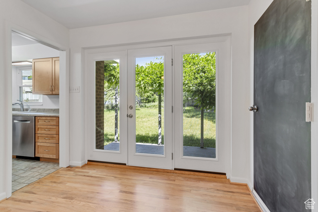 Doorway to outside with light tile floors