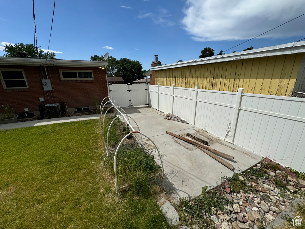 View of yard featuring central AC and a patio area