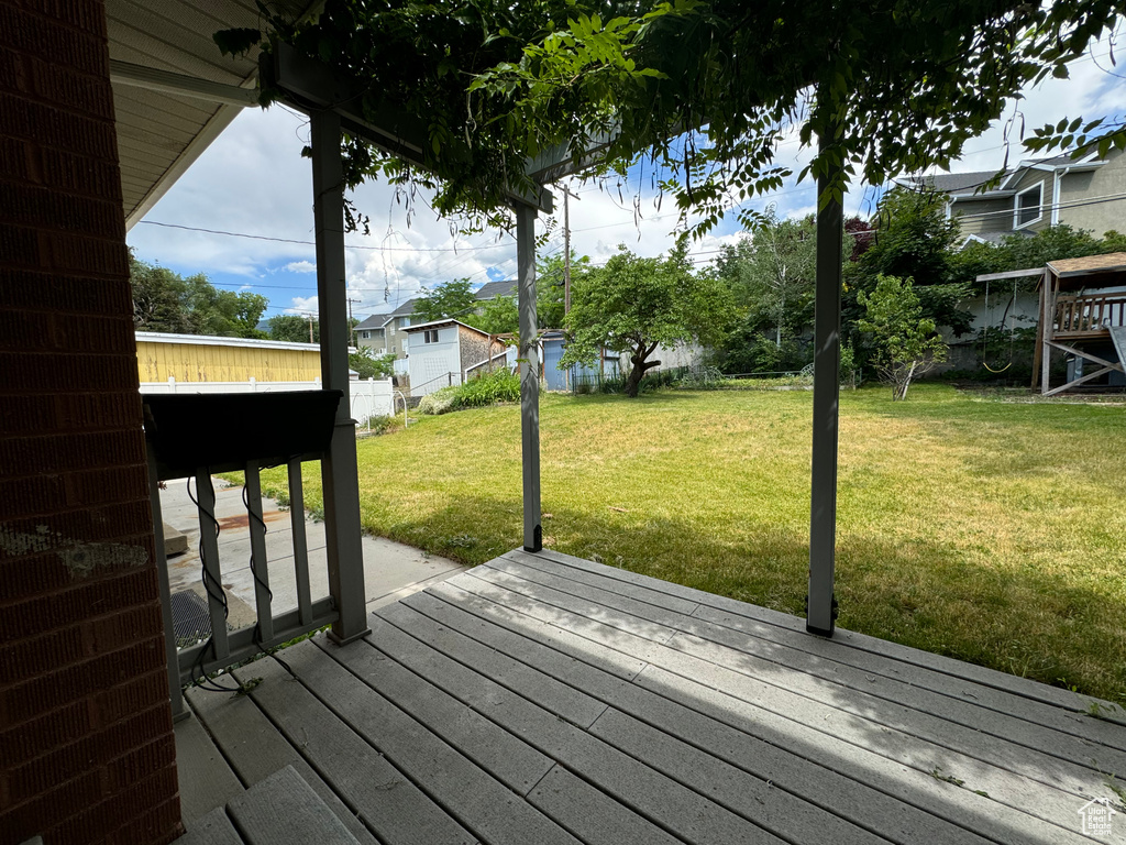 Wooden deck featuring a lawn