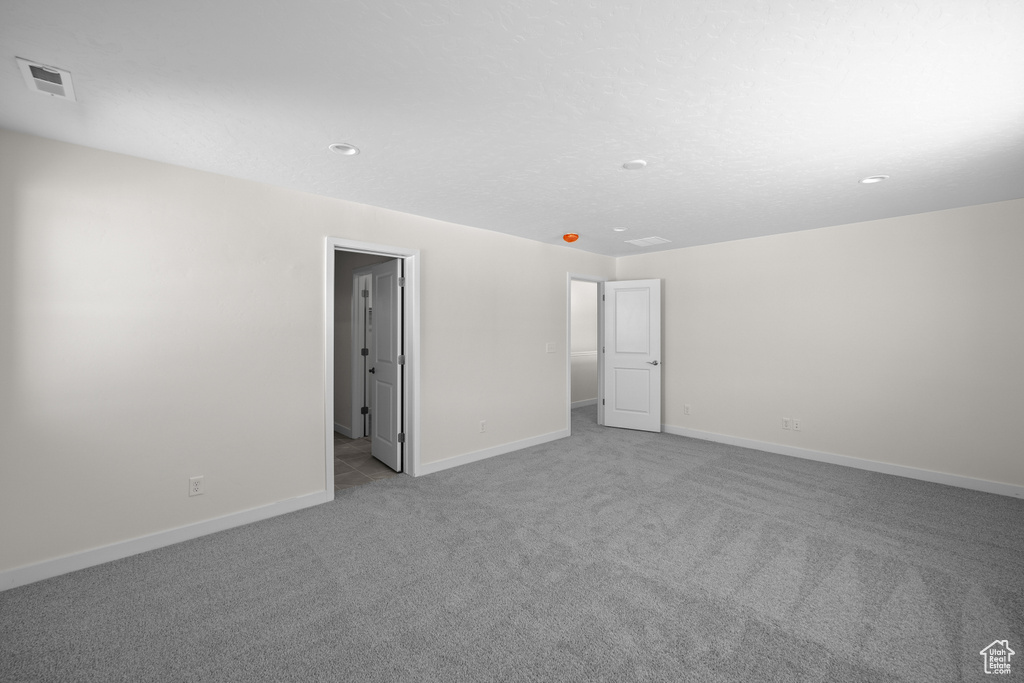 Unfurnished bedroom featuring light colored carpet