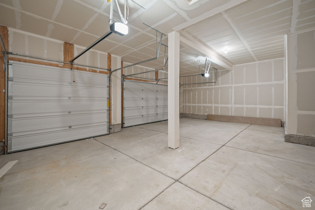 Garage featuring a garage door opener