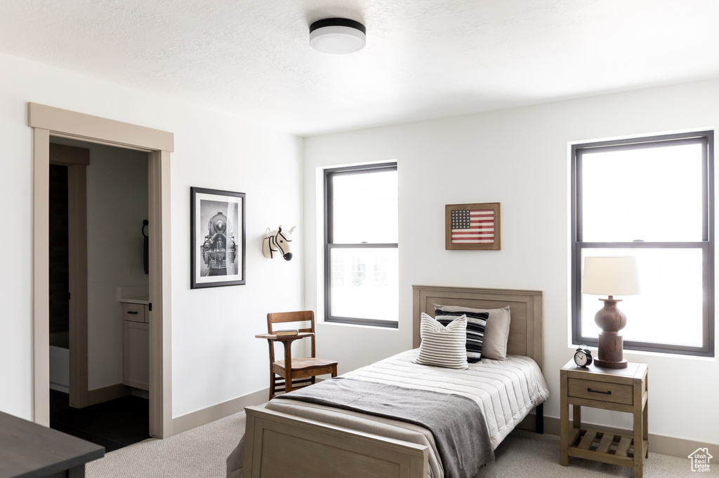 Bedroom with carpet and multiple windows