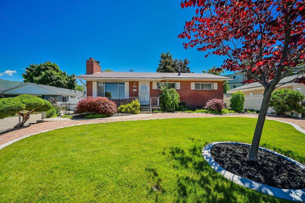 Single story home with a front lawn