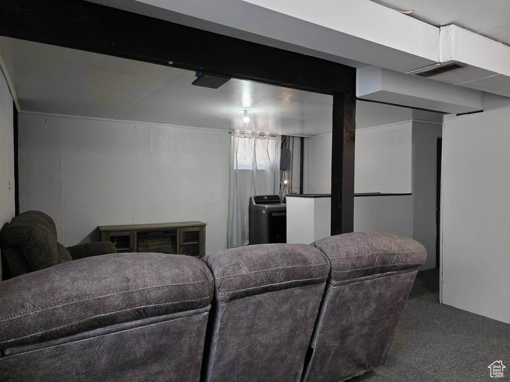 Carpeted living room featuring washer / dryer