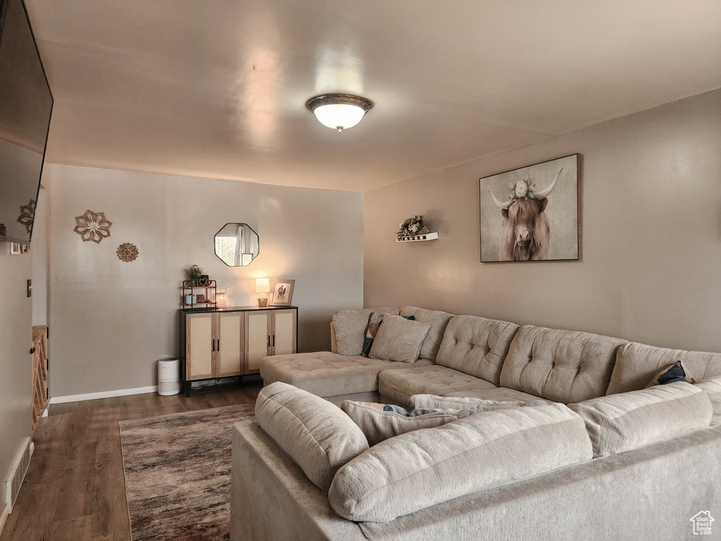 Living area featuring dark wood finished floors and baseboards