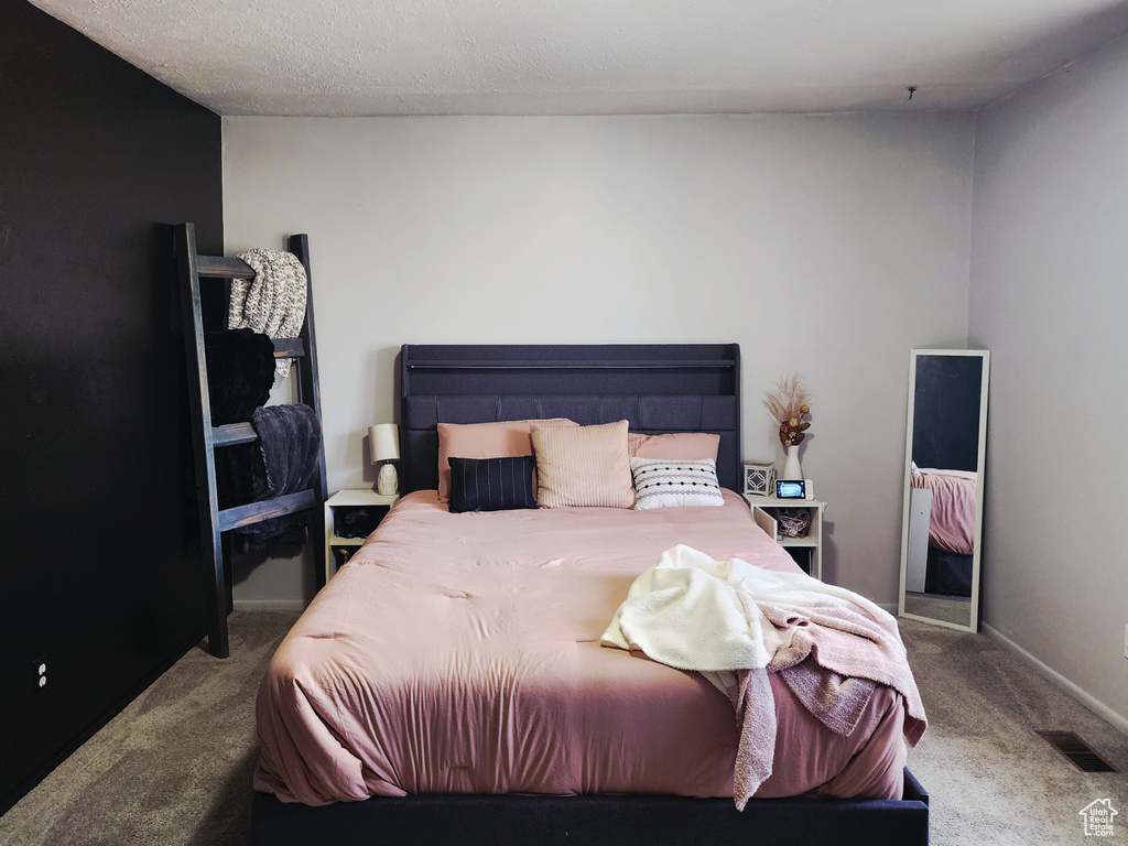 Bedroom with carpet flooring and baseboards
