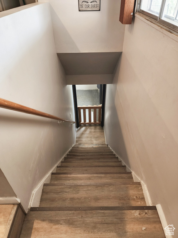 Staircase with hardwood / wood-style floors