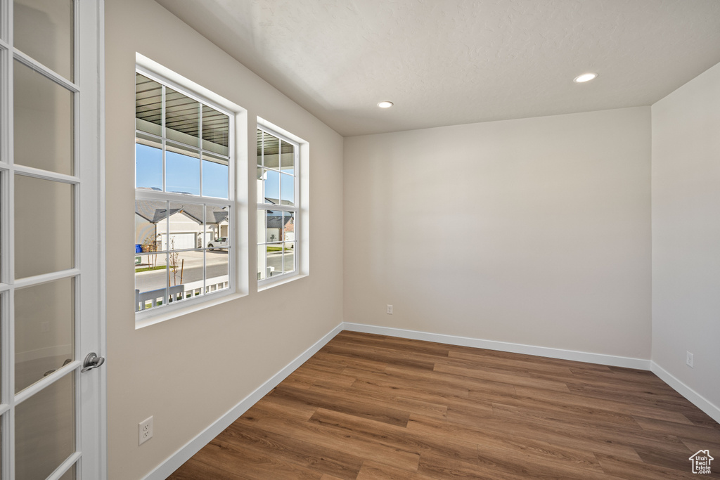 Spare room with dark hardwood / wood-style floors