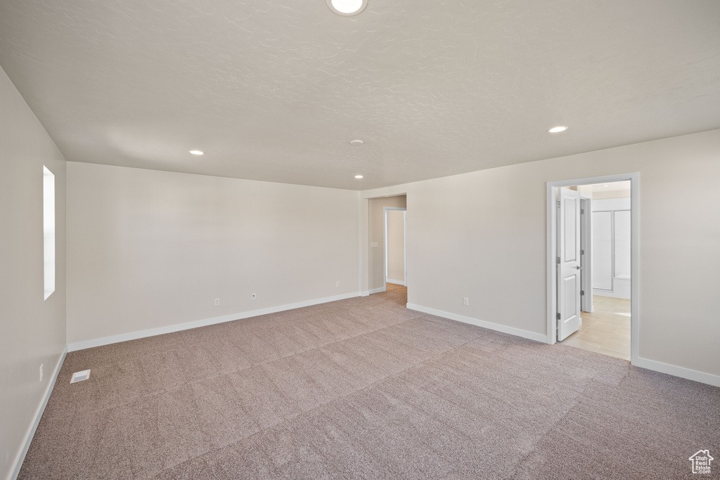 Empty room featuring light colored carpet