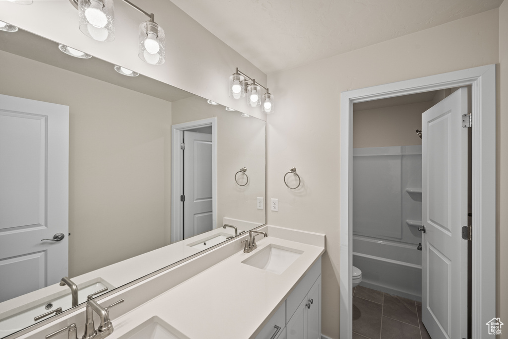 Full bathroom with tile patterned flooring, shower / bathing tub combination, vanity, and toilet