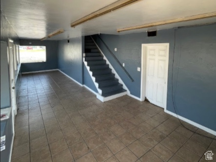 Interior space featuring dark tile floors