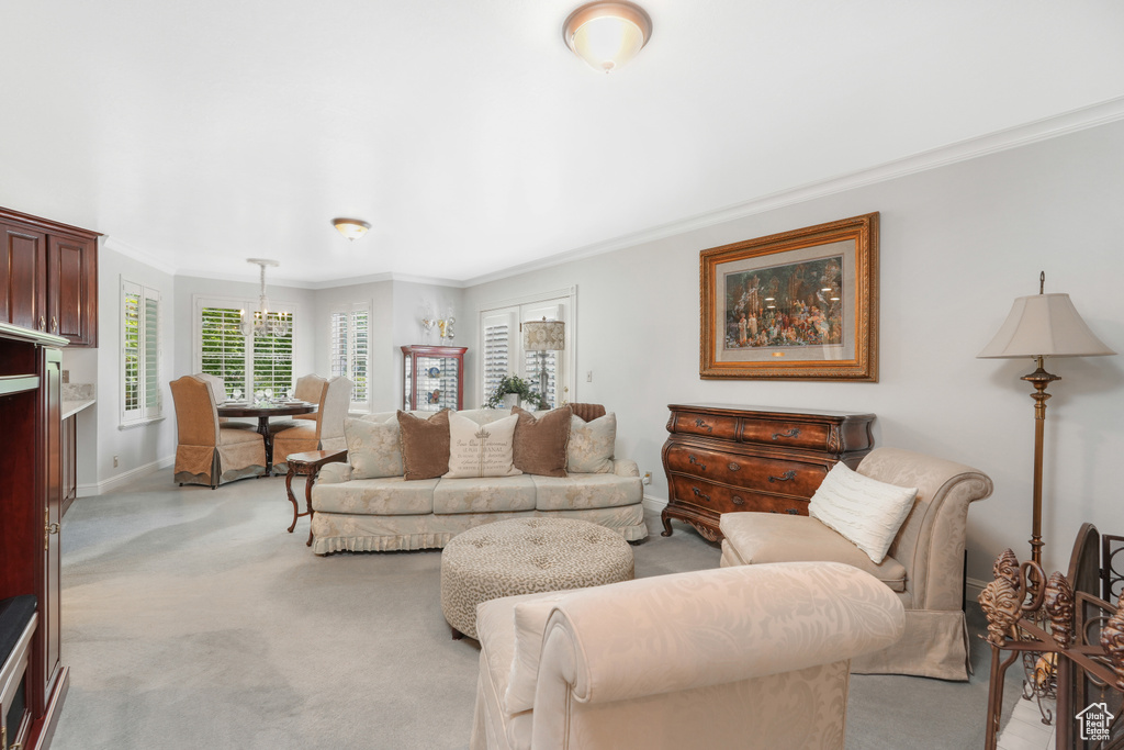 Living room with light carpet and crown molding